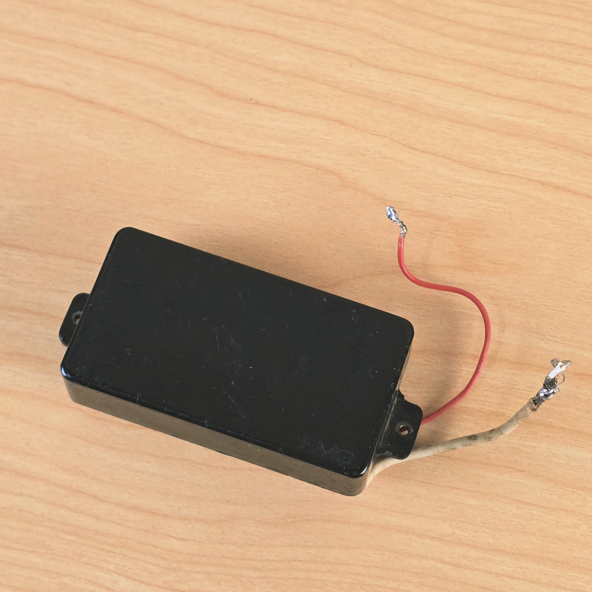 Top-down angle of the EMG 81 pickup resting on a wood surface