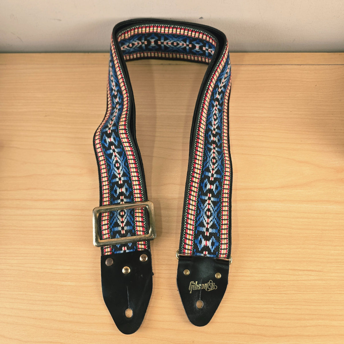 Front-facing view of the vintage Gibson woven strap hanging loosely
