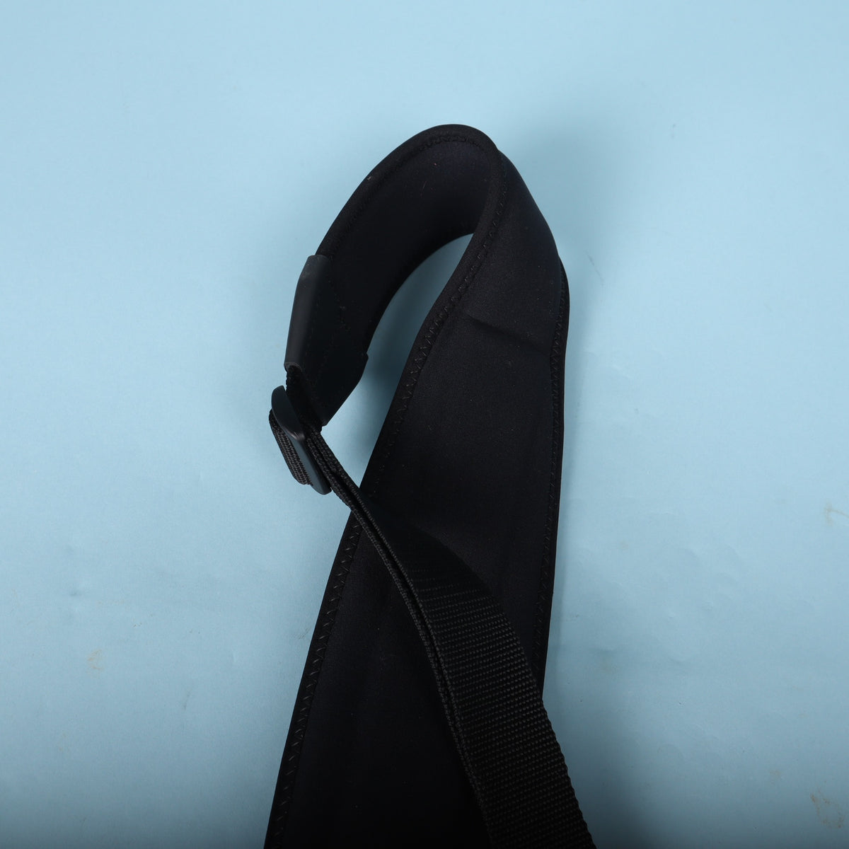 Side view of the curved neoprene padding and hardware slider.