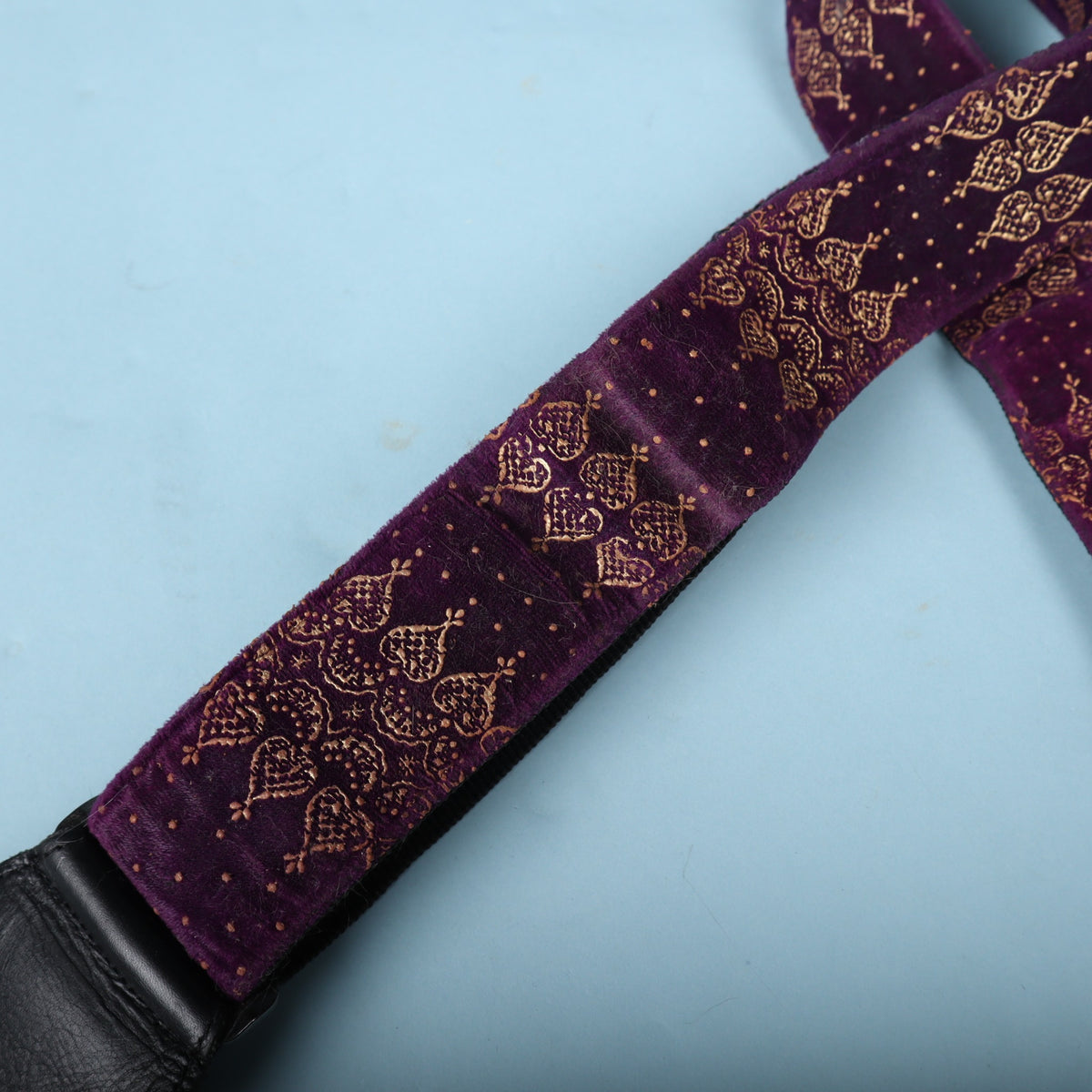 Macro detail of the purple crushed velvet fabric and gold metallic print