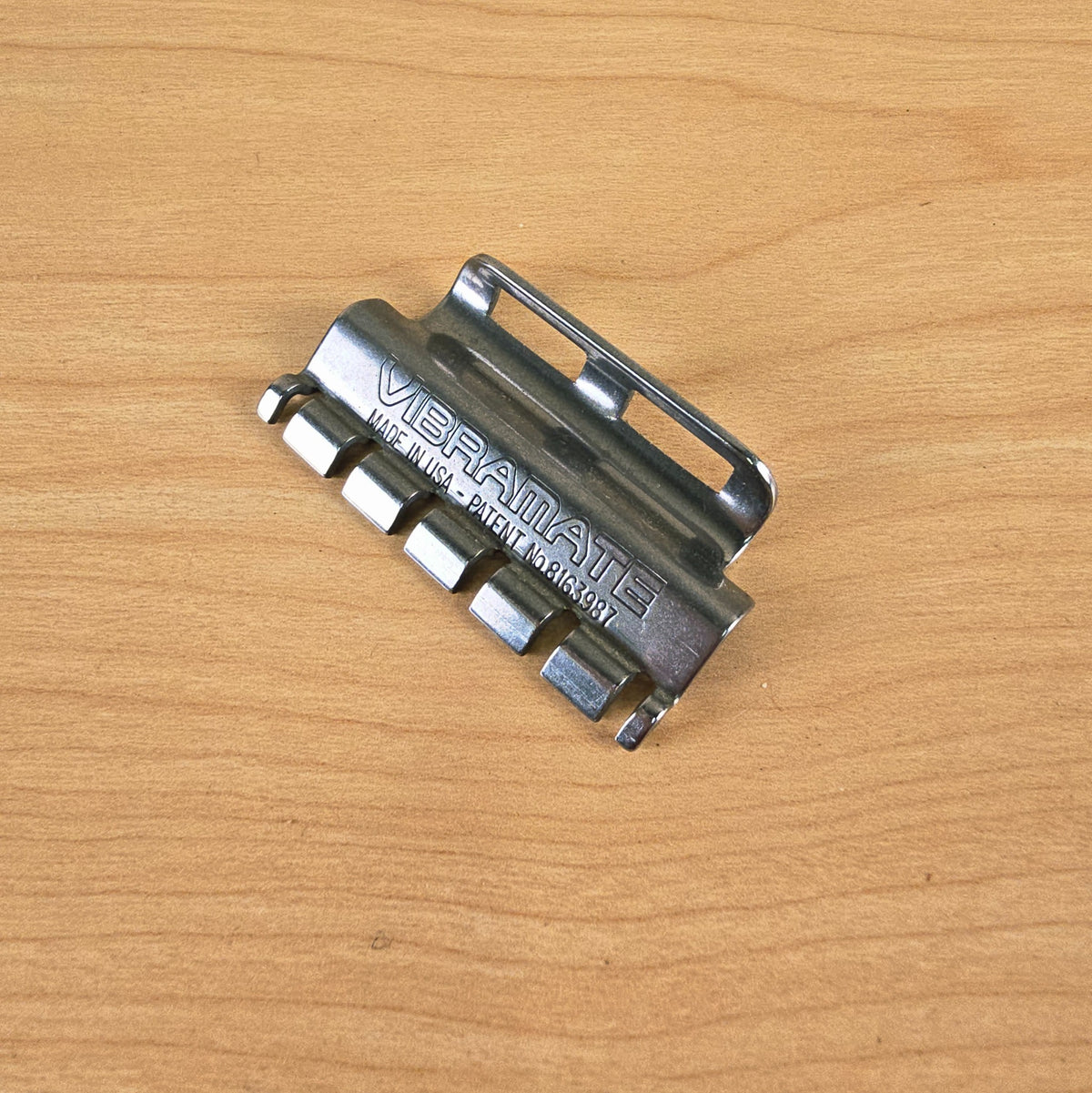 High-angle view of the Vibramate Spoiler positioned on a wood tabletop.
