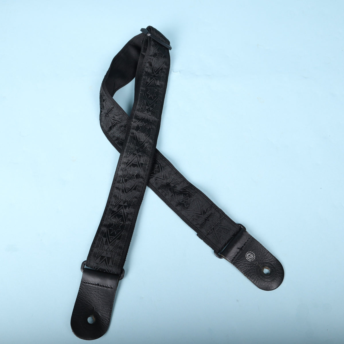 Overhead view of the complete Planet Waves black woven guitar strap.