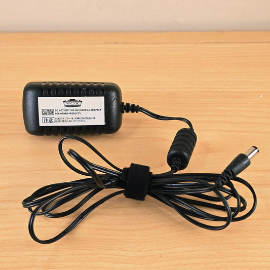 Vox KA253V AC power adapter shown with cable wrapped by hook-and-loop strap