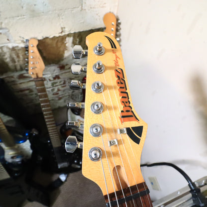 Detailed view of bridge saddles, pickups, and lower body finish reflections.