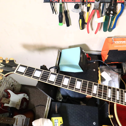 Body top and pickups view of Epiphone Les Paul Custom on tech station