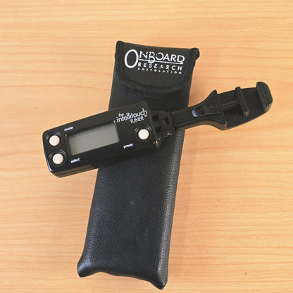 Overhead view of The Intellitouch Tuner positioned next to the branded pouch.