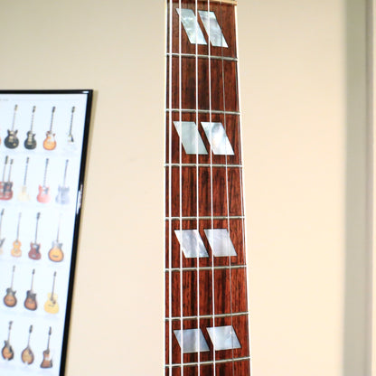 Close-up of the rosewood fretboard showing mother-of-pearl split parallelogram inlays.