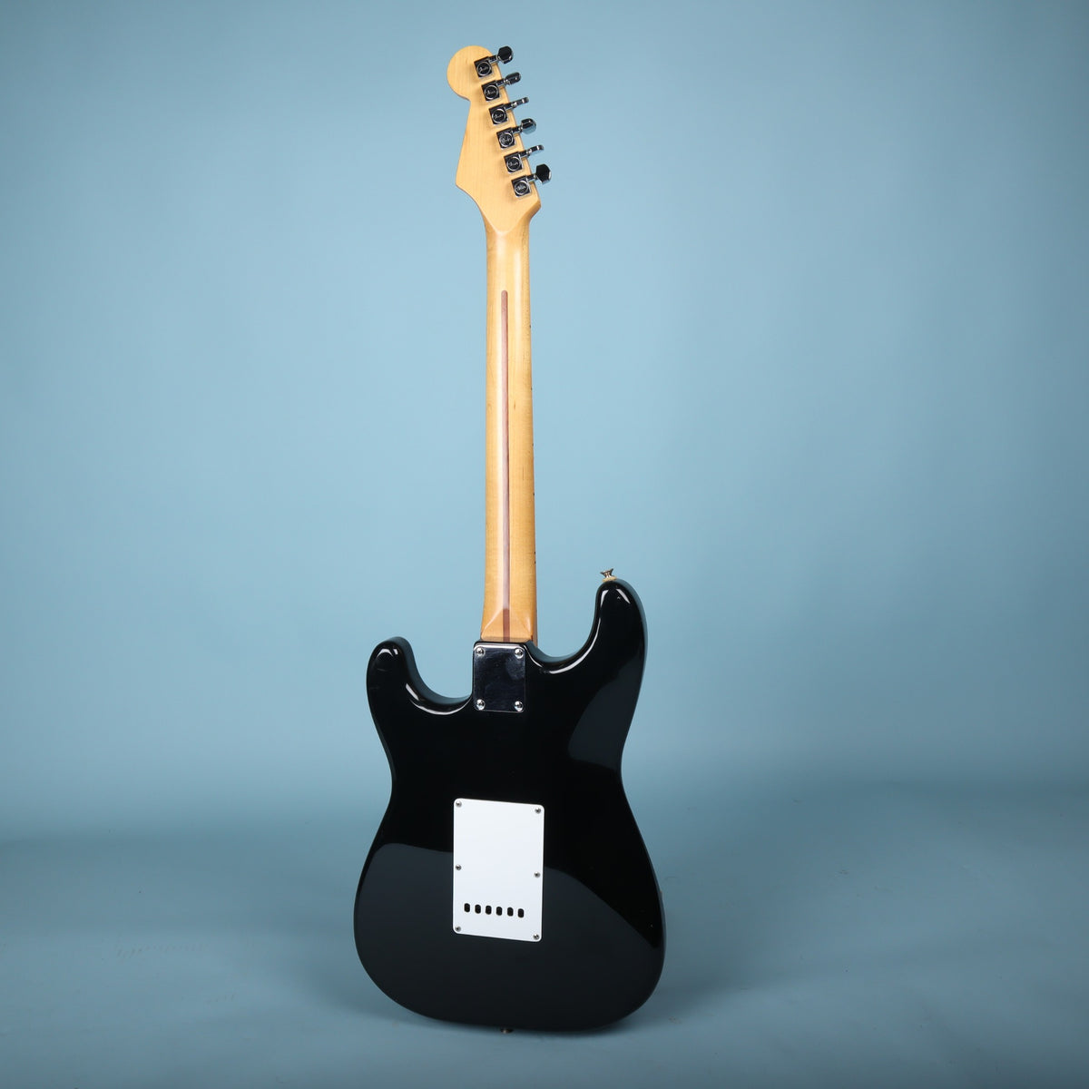 Full rear view of the guitar on stand