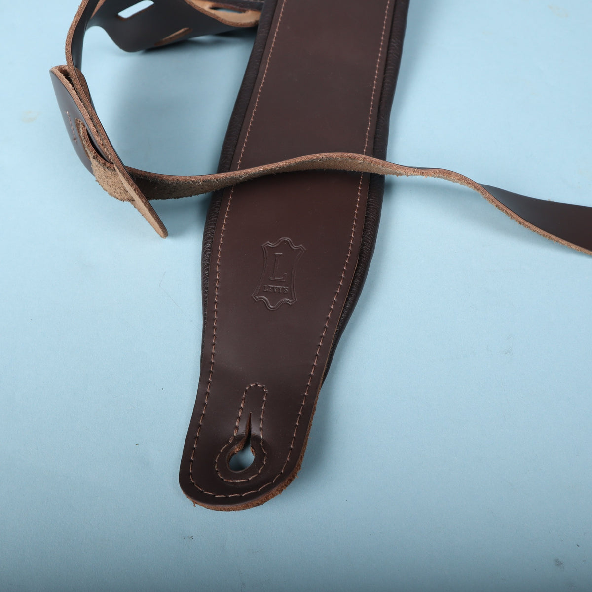 Lower end of the strap showing the embossed Levy's logo and keyhole pin slot