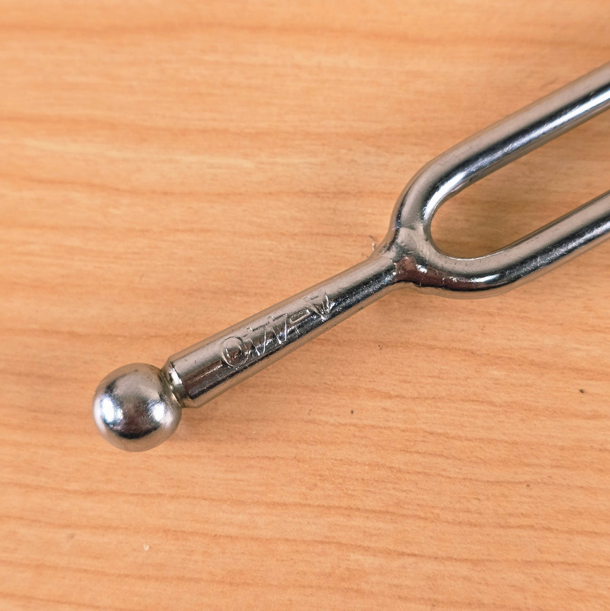 Detailed view of the stem and ball-end base showing the stamped A-440 pitch mark