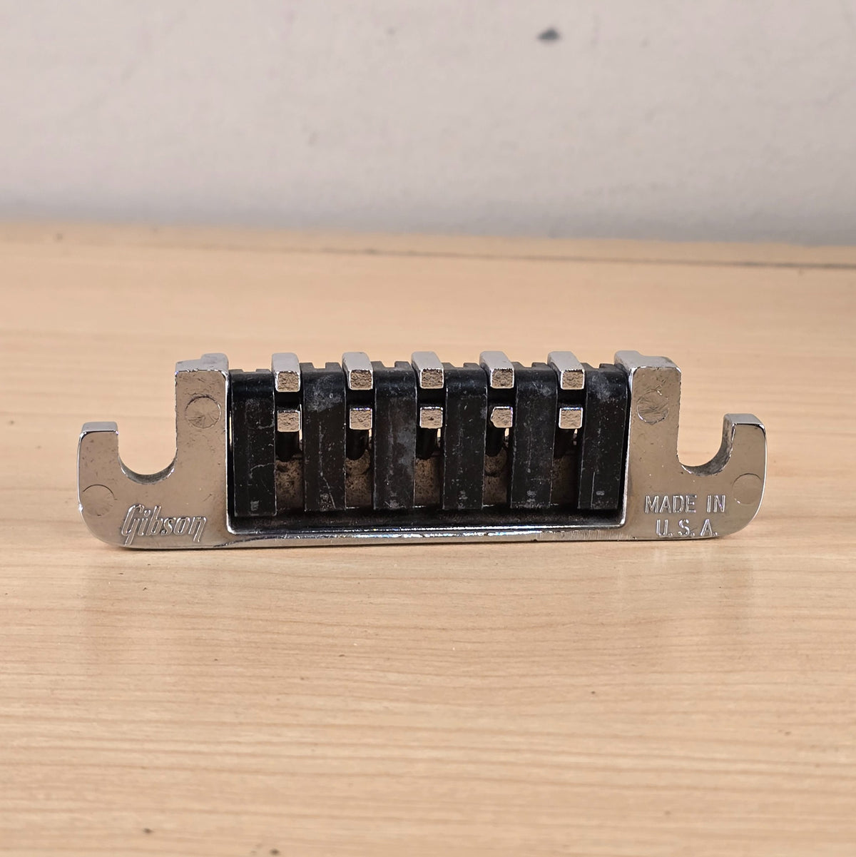 Direct underside view showing the full tailpiece profile, logo, and country of origin