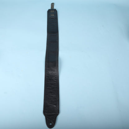 Full-length rear view of the black leather strap showing its padded lining and adjustable tail.