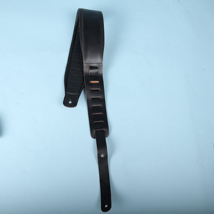 Levy's 3-inch padded leather bass strap folded with adjustment tail extended against a light blue background.
