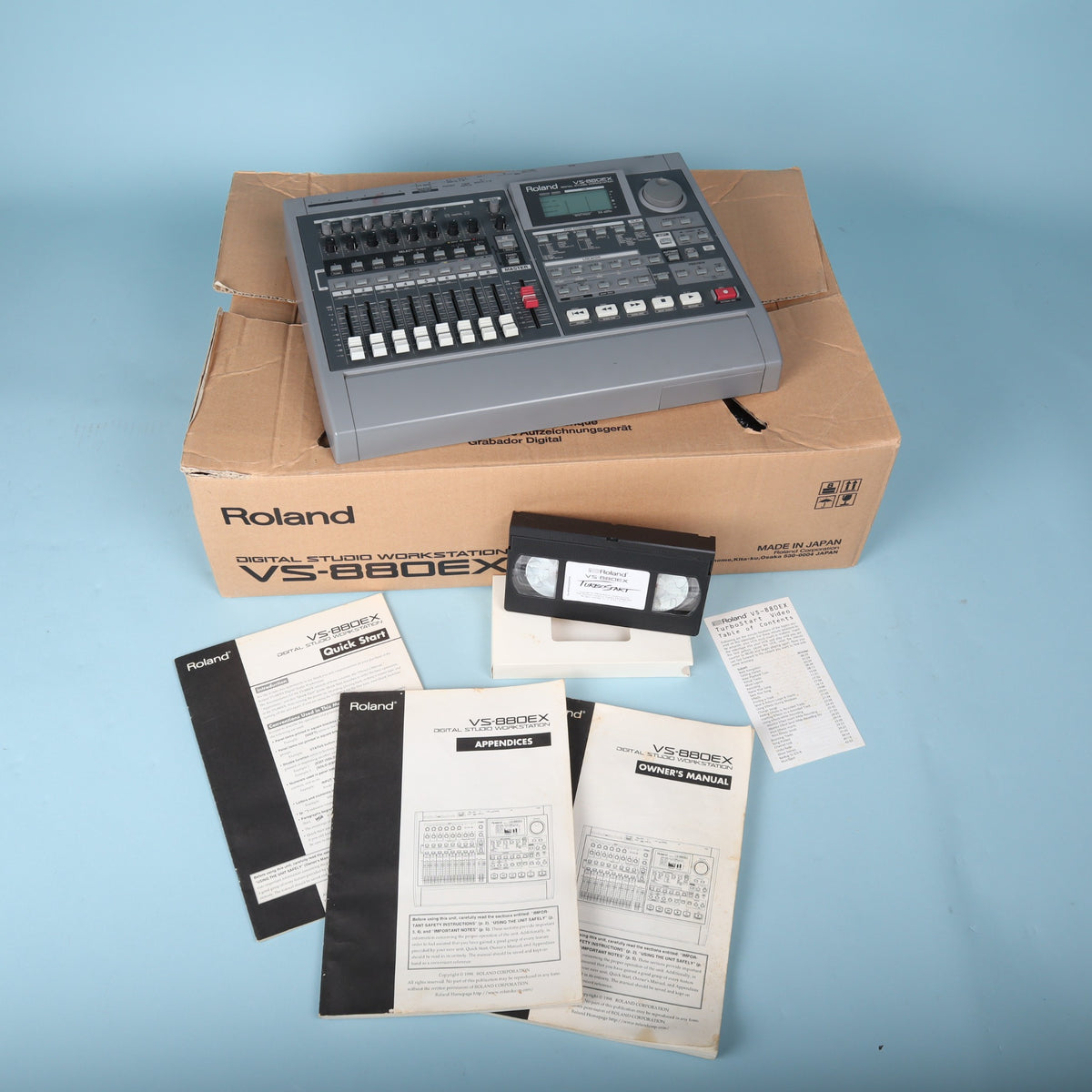 Roland VS-880EX Digital Studio Workstation with original box, printed manuals, and TurboStart VHS tape.