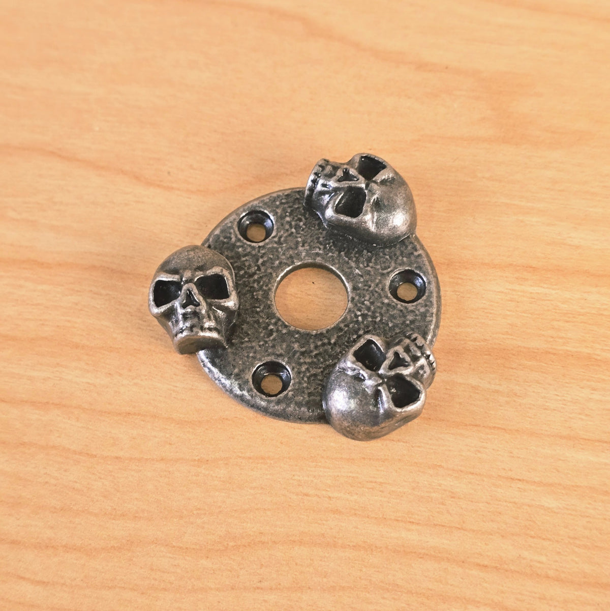 Angled front view of the Gunther skull guitar plate highlighting the three-dimensional skull detailing.
