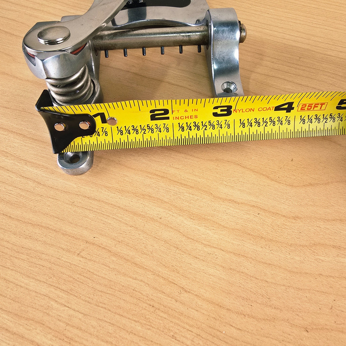 Top mounting hole spacing measured with a tape measure, showing roughly 2 1/8 inches center-to-center.