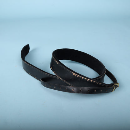 Gretsch black leather guitar strap showing metal adjustment buckle and tail holes.