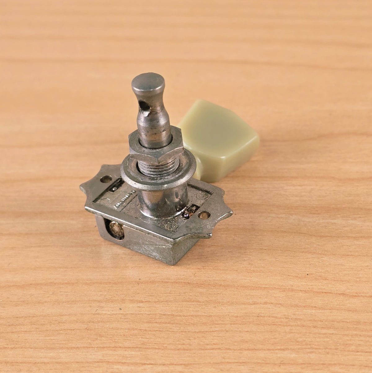 Perspective view focusing on the tuner post and washer assembly.