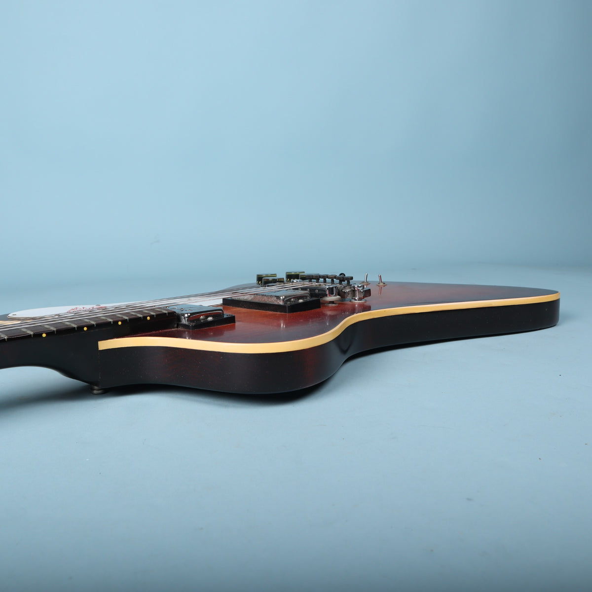 Bass-side profile view showing the body edge, binding, and neck profile.
