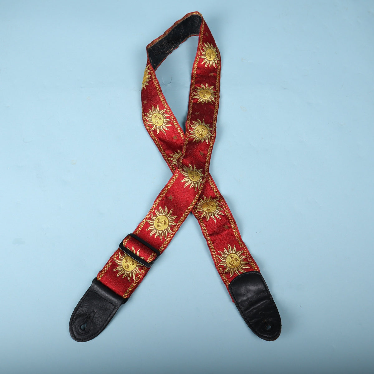 Front layout of the red and gold celestial sun Levy's guitar strap