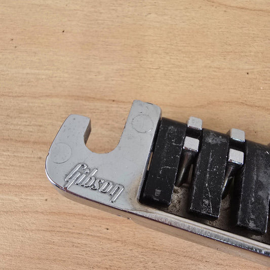 Close-up of the embossed Gibson script logo on the mounting ear