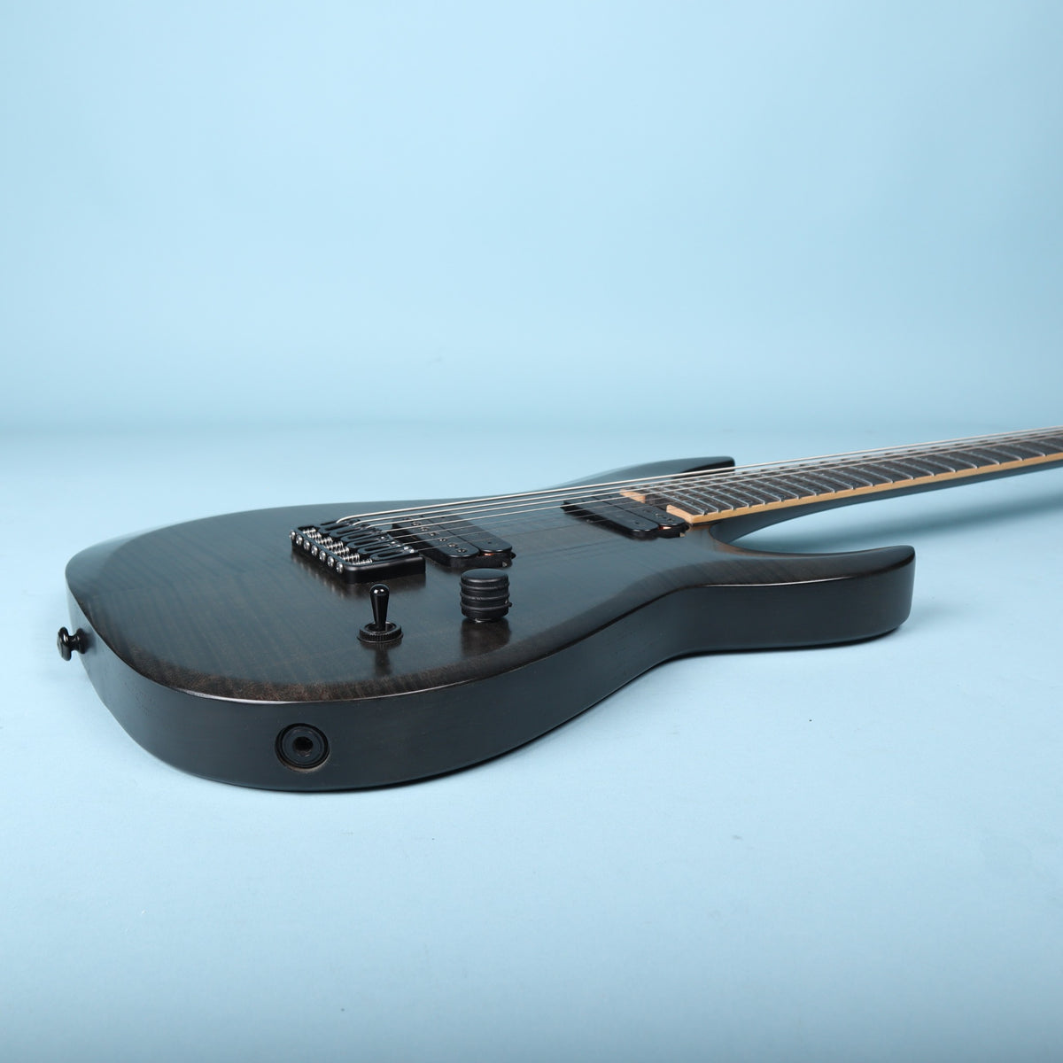 Side view of the body edge showing the flush-mount input jack and control profile