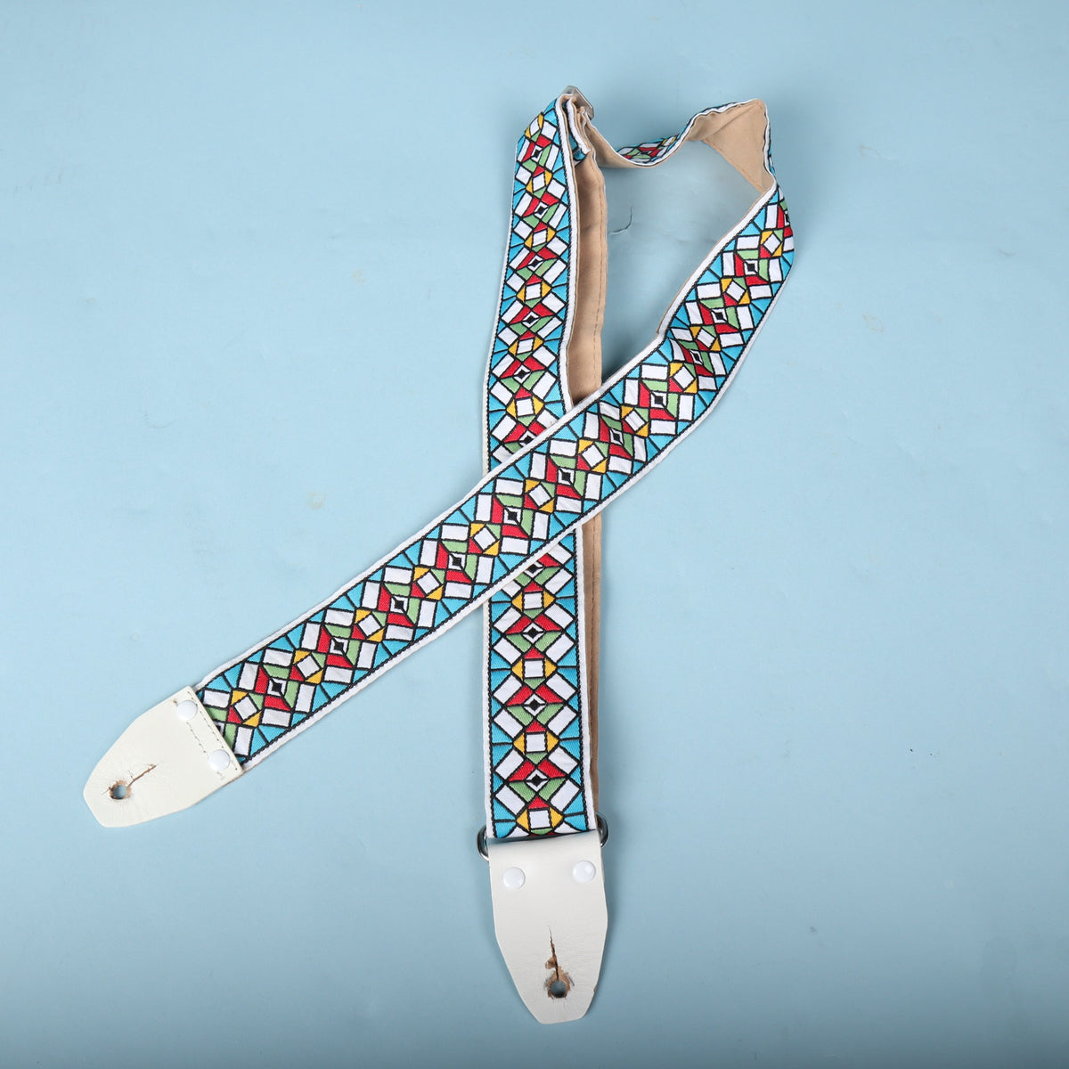 Front side view of the folded Authentic Hendrix guitar strap displaying both end tabs