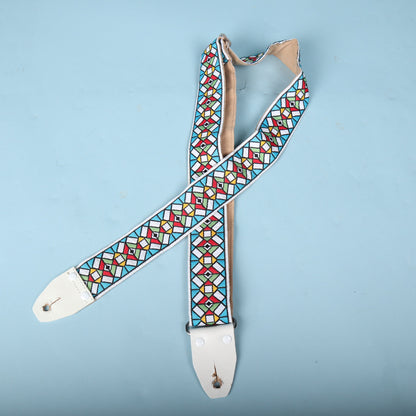 Front side view of the folded Authentic Hendrix guitar strap displaying both end tabs