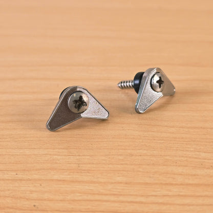 Close-up of chrome triangular guitar string retainers highlighting the finish and screws.
