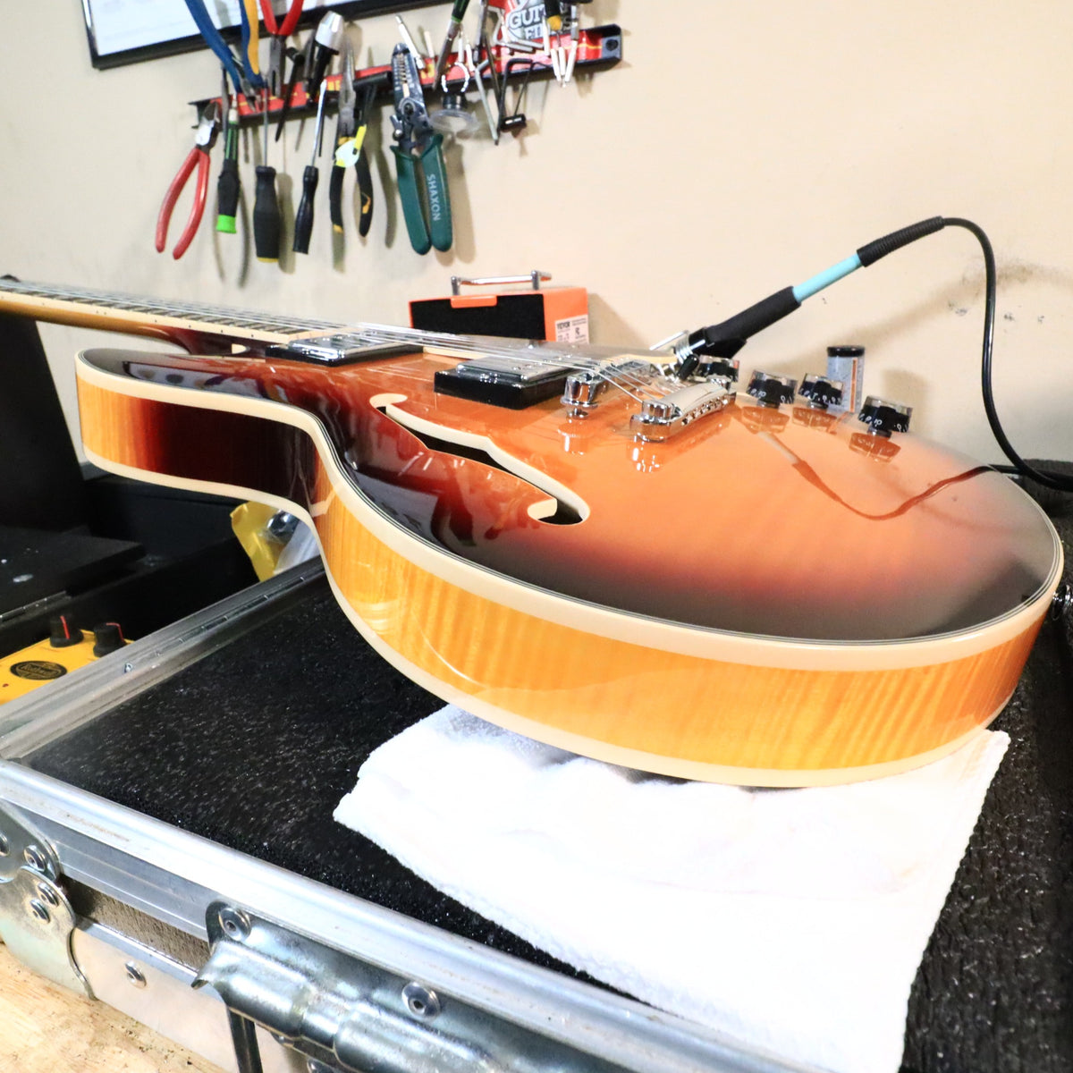 Bass-side rim and binding profile of the guitar on the workbench.