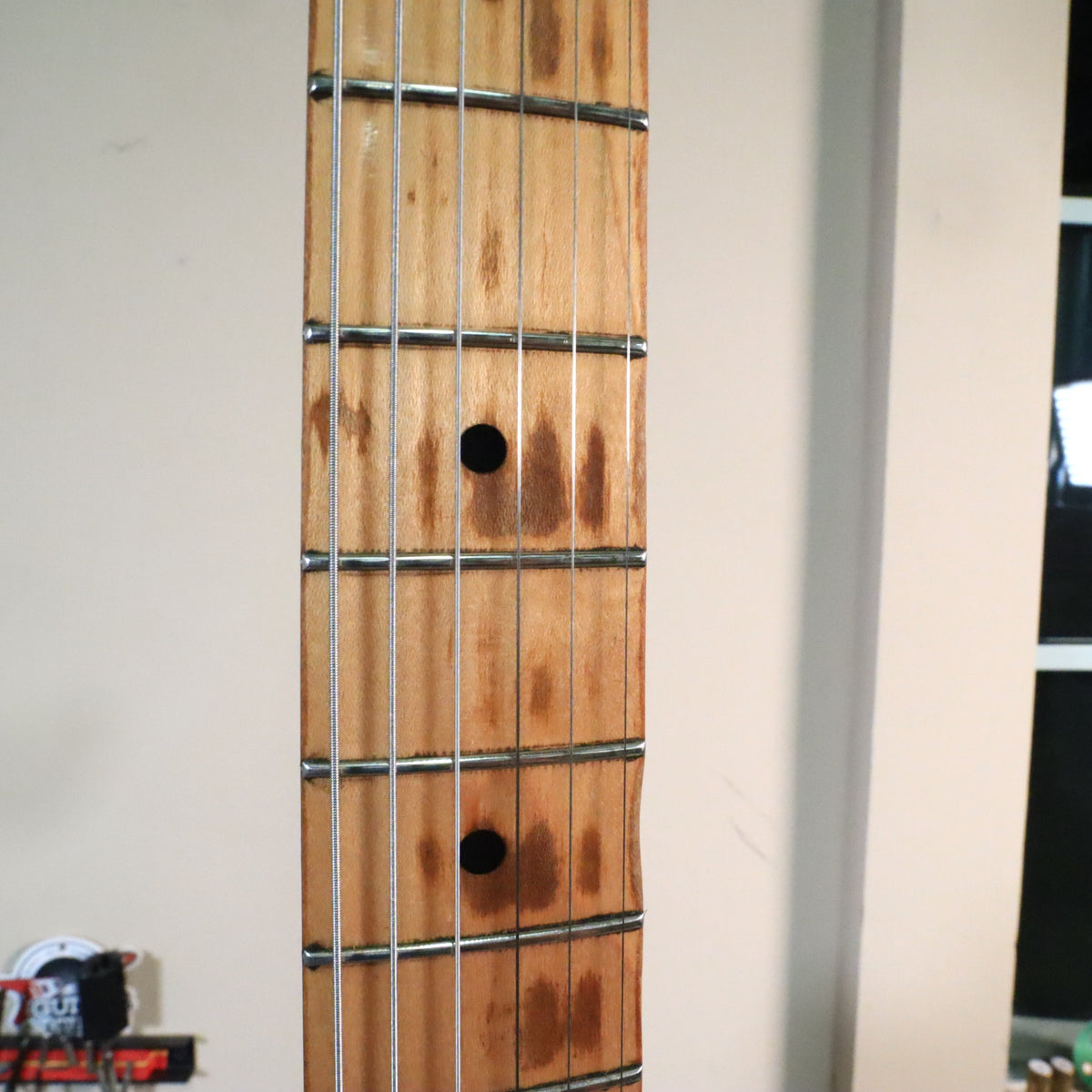 Detailed view of maple neck fretboard wear and fret wire condition