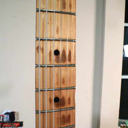 Detailed view of maple neck fretboard wear and fret wire condition