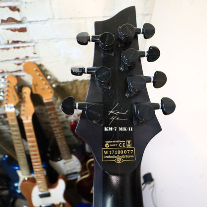 Rear neck shaft view on workbench displaying wood grain texture