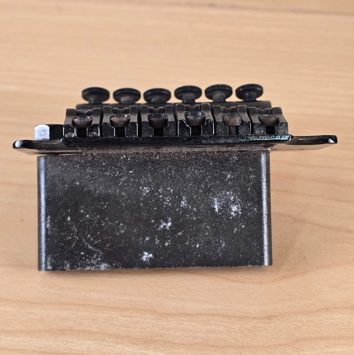 Rear profile view of tremolo block and saddle hardware