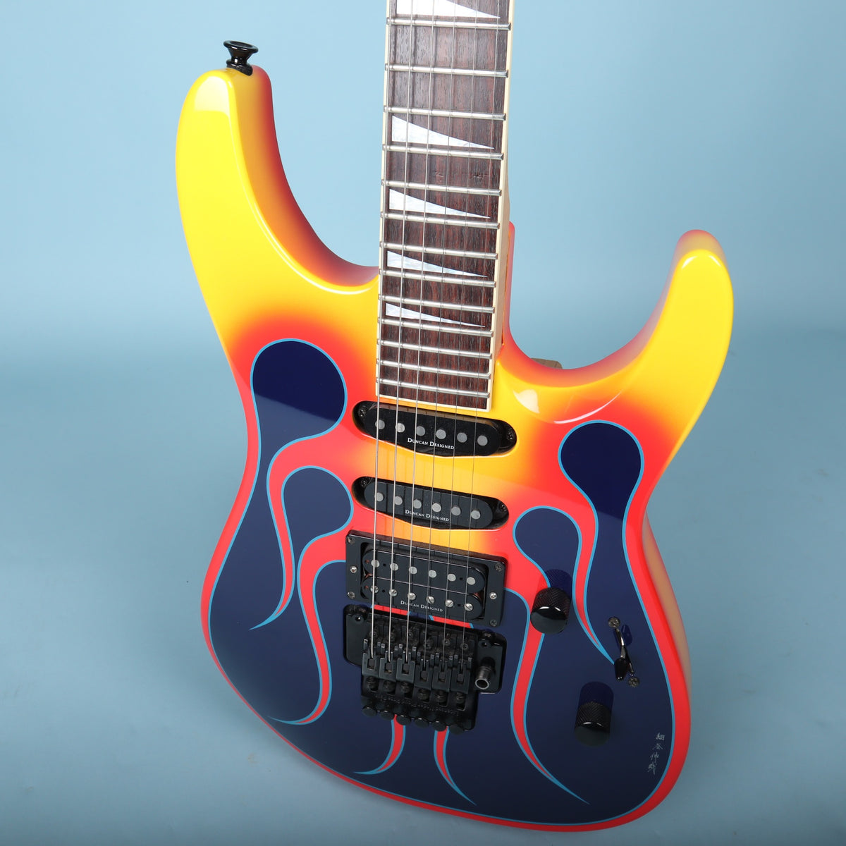 Angled front view showing flame graphic, pickup layout, and body contouring