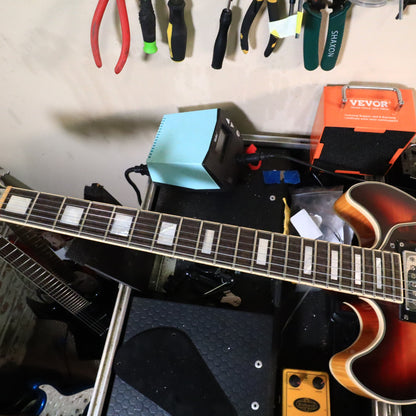 Fretboard and upper body cutaways of the Premier Mini DC on the workbench.