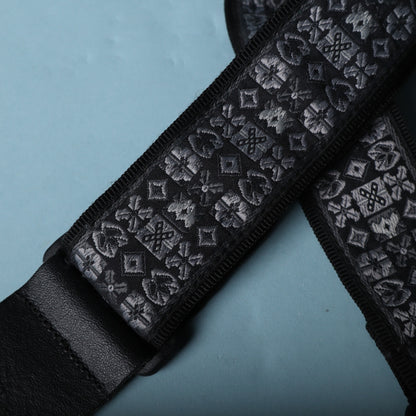 Detailed view of the grey and black geometric jacquard woven strap fabric.