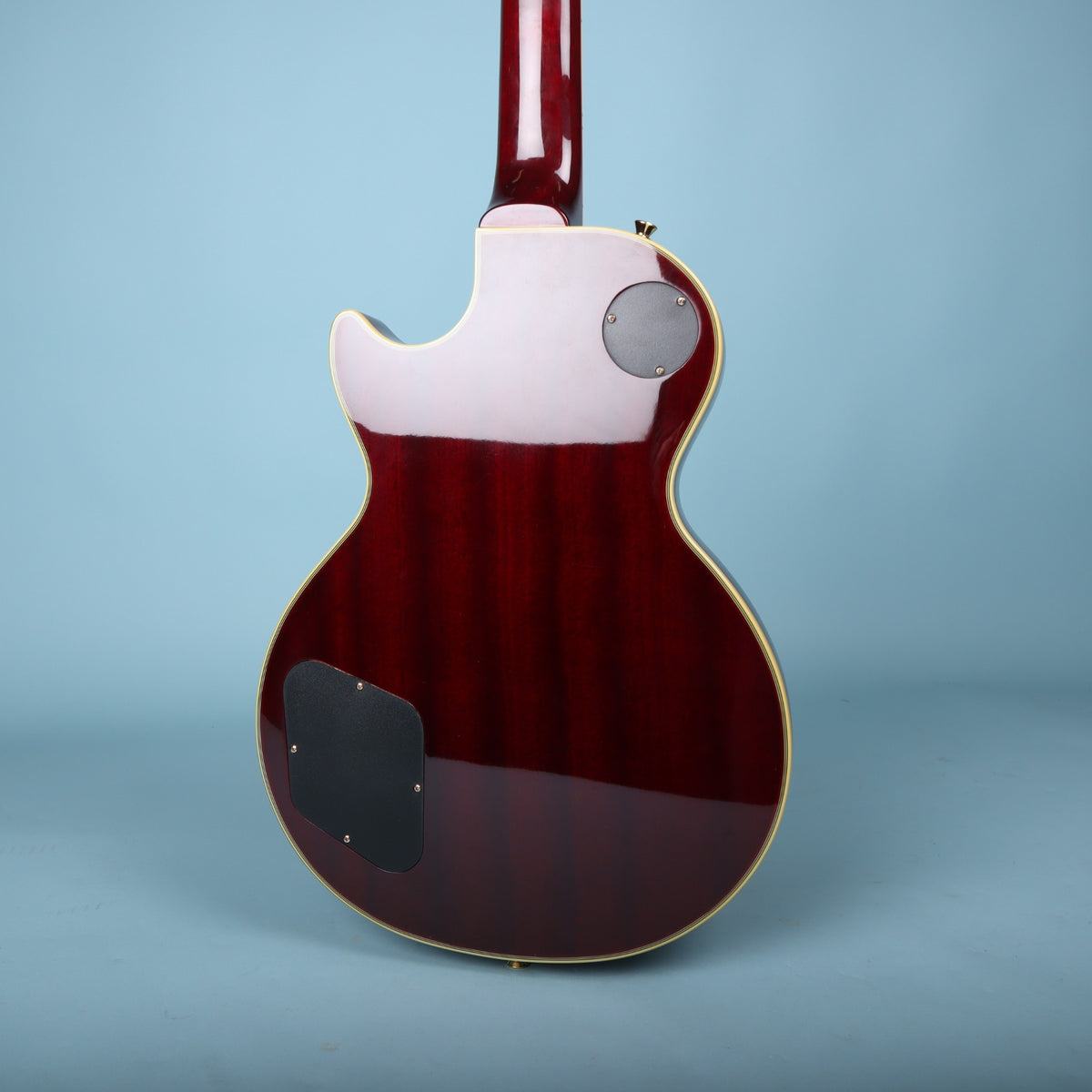 Back view of Epiphone Les Paul Custom body showing mahogany grain and dark red finish