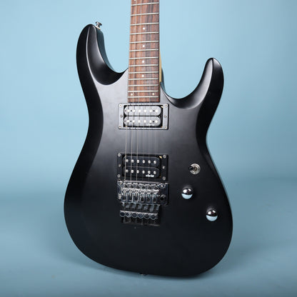 Front view of the Schecter C-6 Deluxe FR body in satin black showing pickups and Floyd Rose bridge.