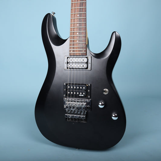 Front view of the Schecter C-6 Deluxe FR body in satin black showing pickups and Floyd Rose bridge.
