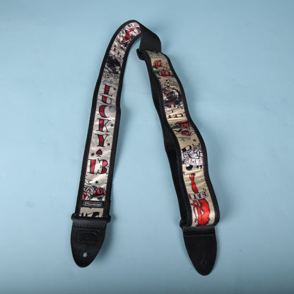 Front-facing view of the complete Dunlop Lucky 13 guitar strap