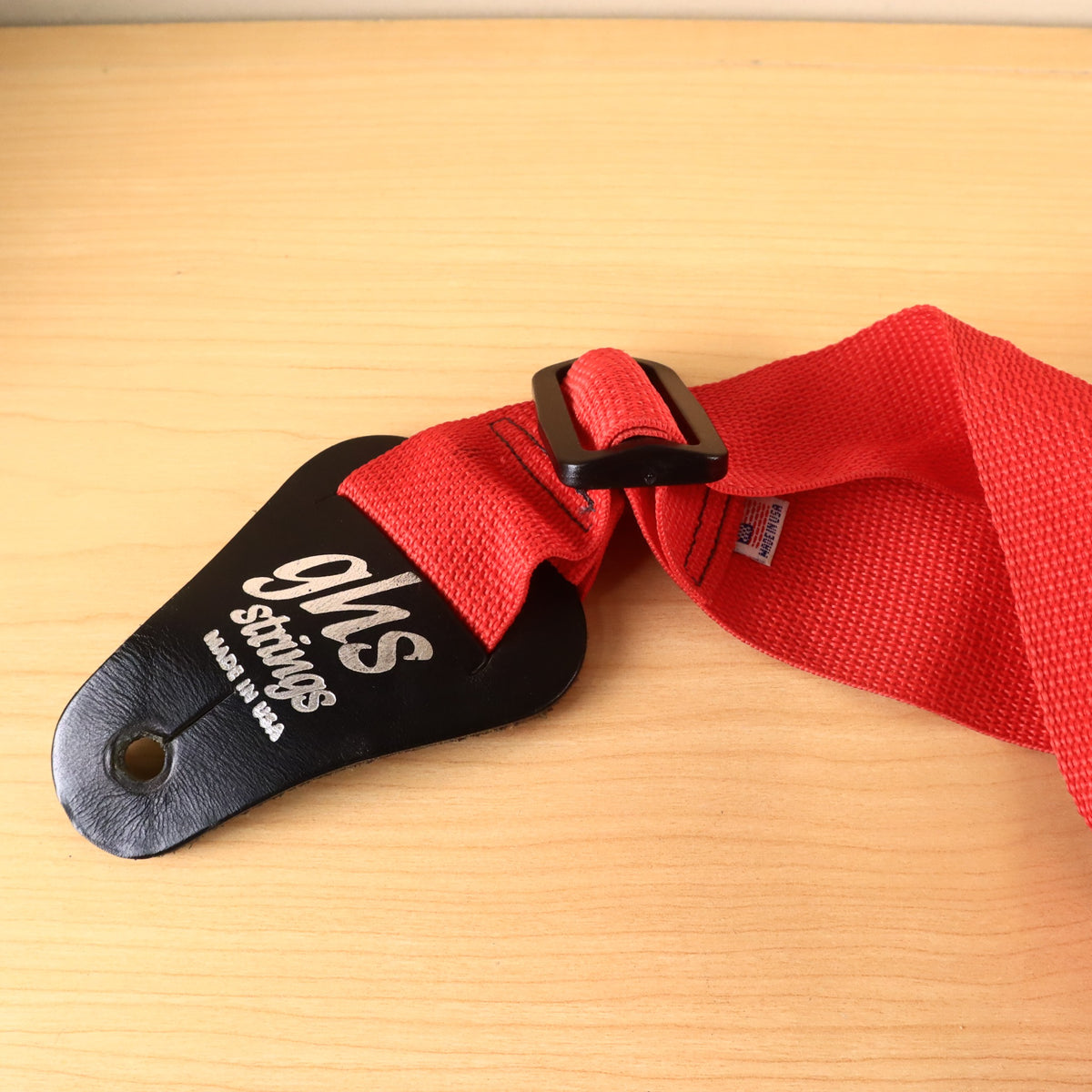 Angled close-up of GHS logo end tab and black adjustment hardware.