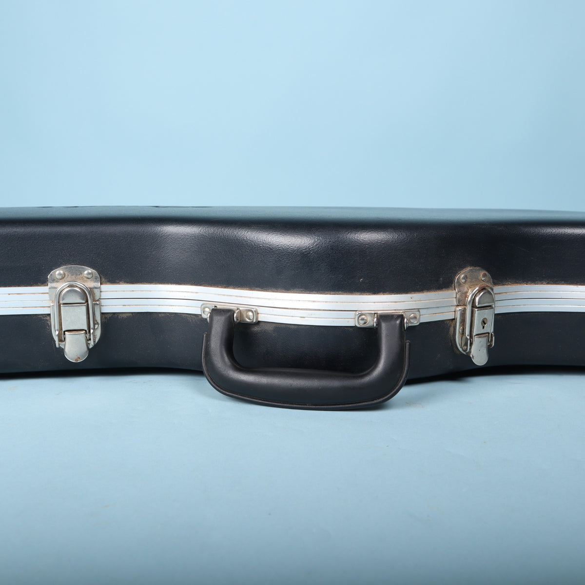 Close-up of molded handle and center latch on Fender electric guitar case