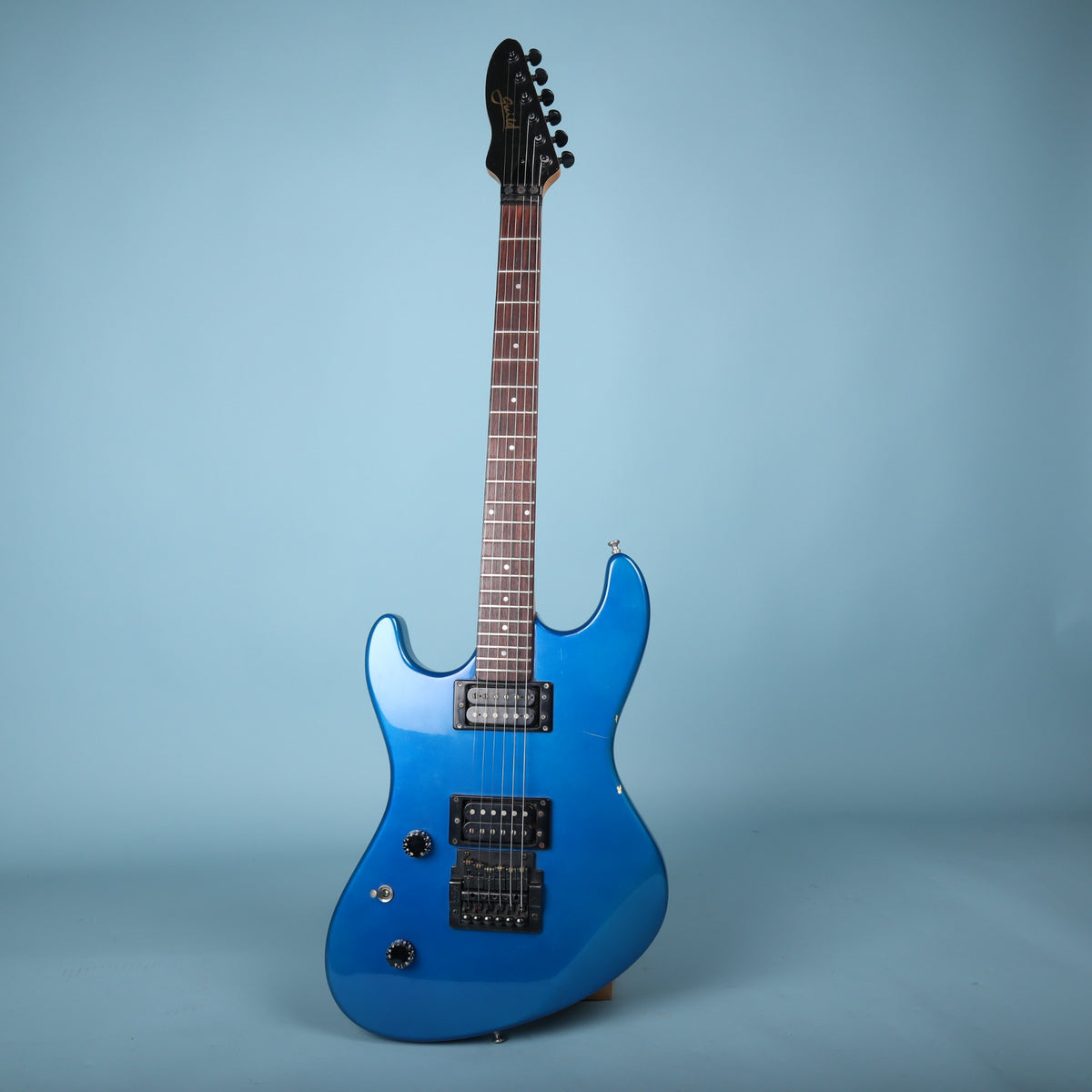 Full front view of the Guild Flyer electric guitar against a blue background