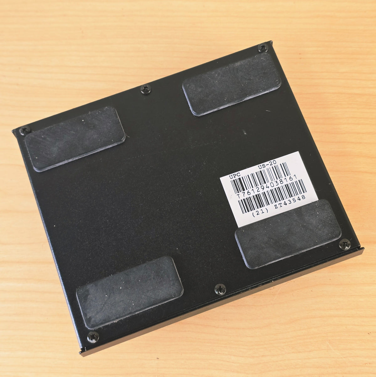 Bottom metal panel of Roland US-20 with four rubber feet and product sticker.
