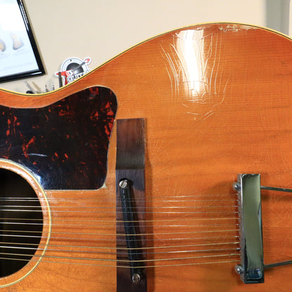 Close-up of the adjustable rosewood bridge and pickguard on a Gibson B-25-12.