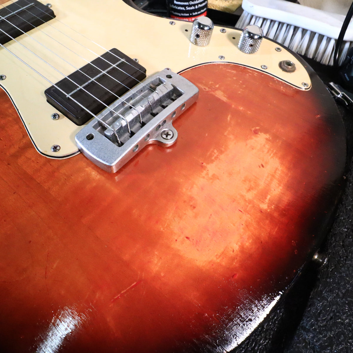Close-up showing finish hazing and wear on the lower body face.