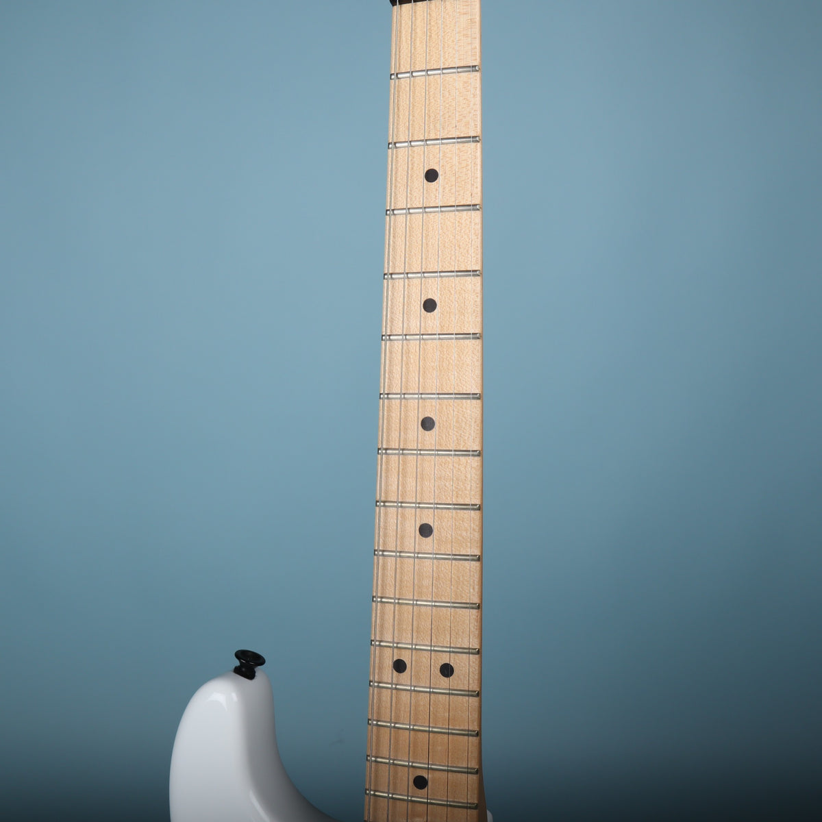 Maple fretboard with black dot inlays and jumbo frets.