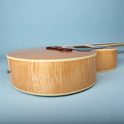 Treble side profile displaying flame maple body rim and cream binding.