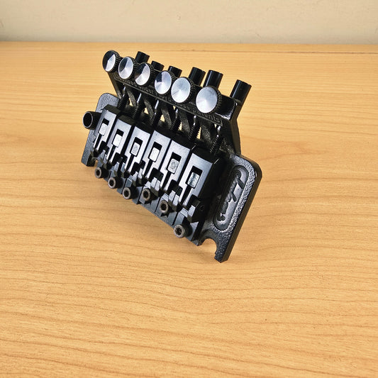 High-angle view of the Jackson tremolo bridge showing fine tuners and saddles.